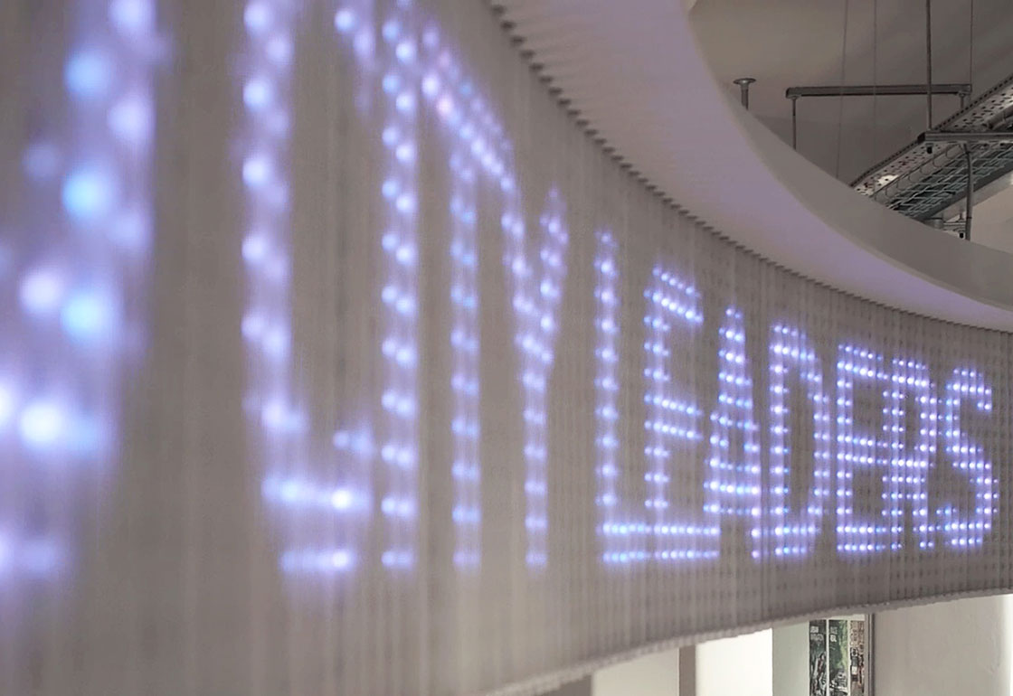 Close-up of LED signage displaying 'City Leaders'