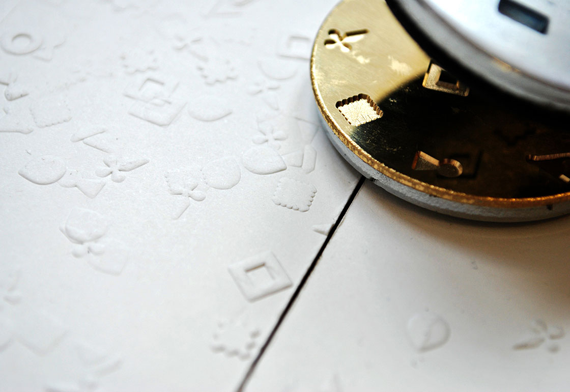 Embossing tool and embossed cards